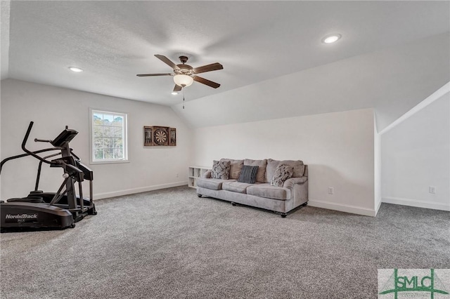 exercise area with baseboards, a ceiling fan, carpet, and lofted ceiling