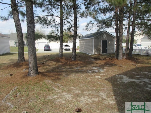 view of yard featuring fence and an outdoor structure