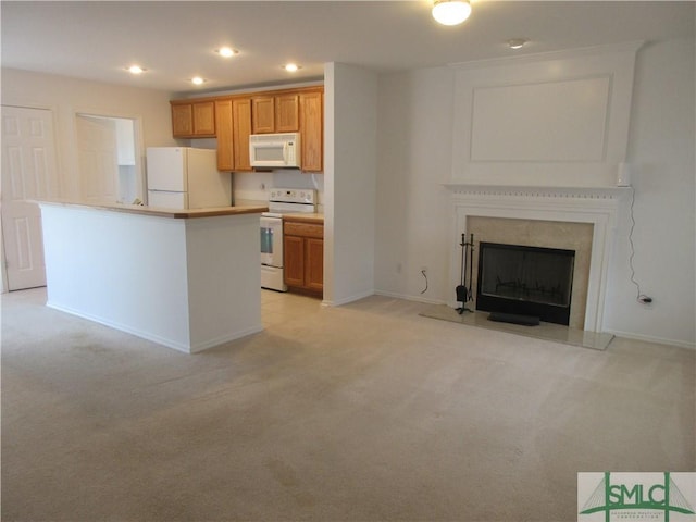 kitchen with light countertops, light carpet, recessed lighting, and white appliances