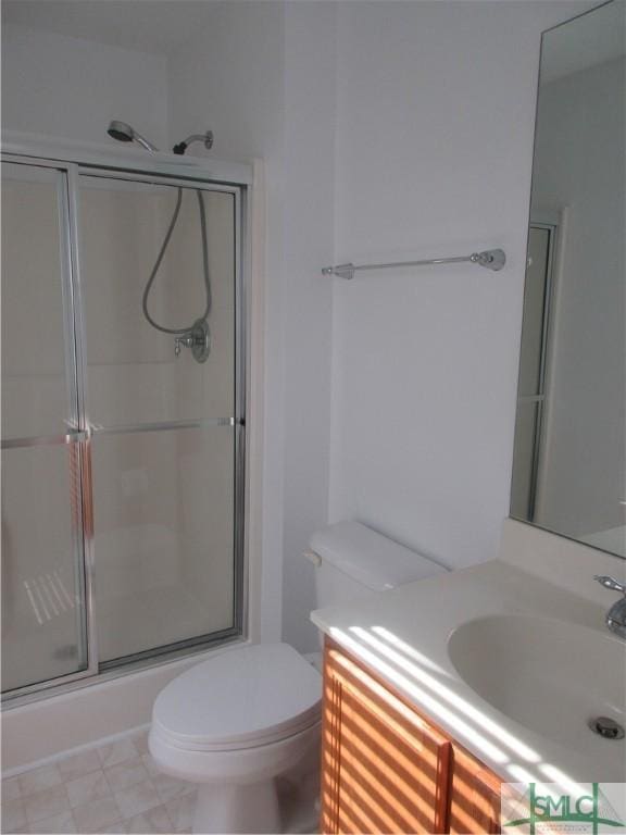 full bathroom with toilet, vanity, and an enclosed shower