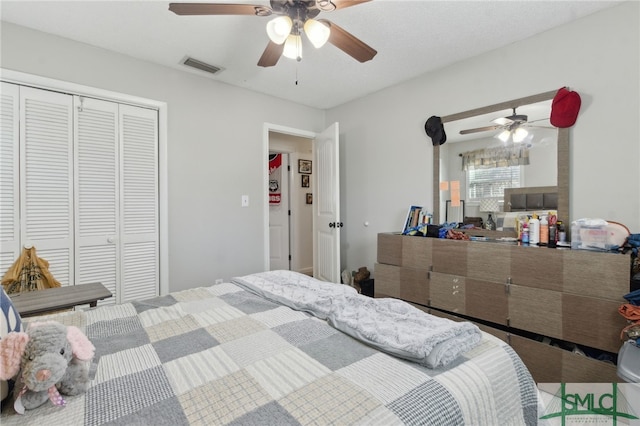 bedroom with a closet, visible vents, and ceiling fan