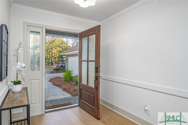 foyer entrance featuring french doors, crown molding, and wood finished floors