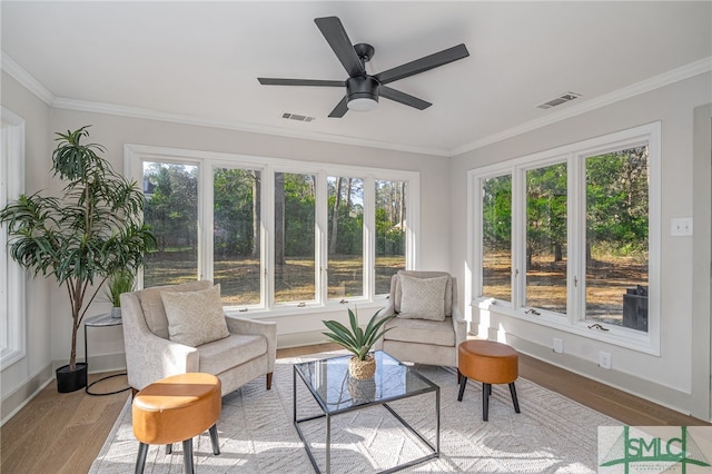 sunroom featuring visible vents and ceiling fan