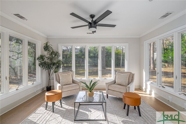 sunroom / solarium featuring visible vents, a healthy amount of sunlight, and ceiling fan