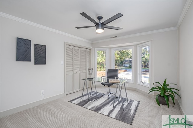 home office with ceiling fan, baseboards, light colored carpet, and ornamental molding