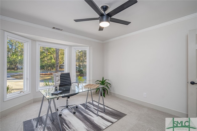 carpeted home office featuring ceiling fan, visible vents, baseboards, and ornamental molding