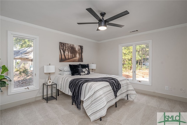 bedroom with visible vents, baseboards, light colored carpet, and crown molding