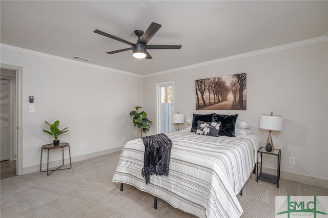 carpeted bedroom featuring crown molding, baseboards, and visible vents