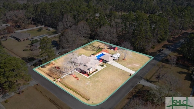 birds eye view of property with a view of trees