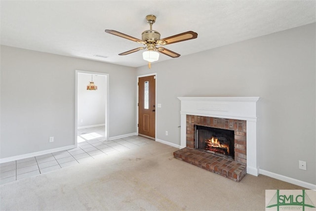 unfurnished living room with carpet flooring, a brick fireplace, and baseboards