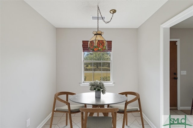 dining area with light tile patterned floors, visible vents, and baseboards