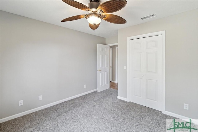 unfurnished bedroom with a closet, visible vents, carpet flooring, and baseboards