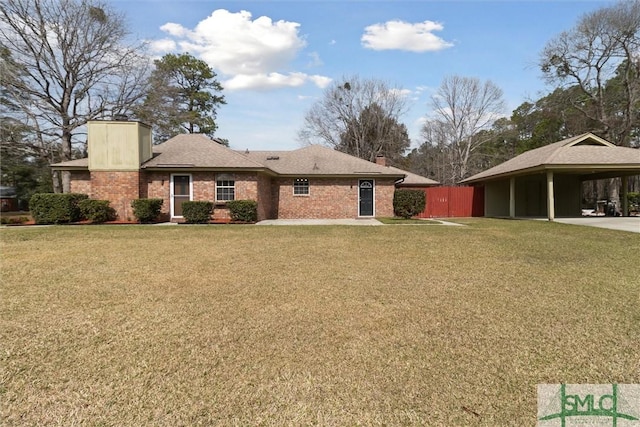 back of property featuring a yard, brick siding, and a chimney