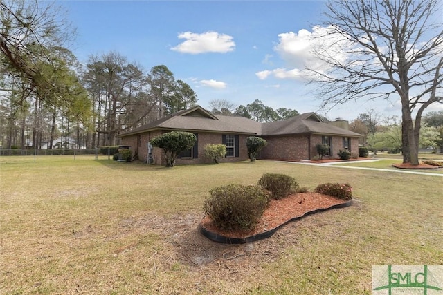 view of property exterior with fence, a lawn, and brick siding