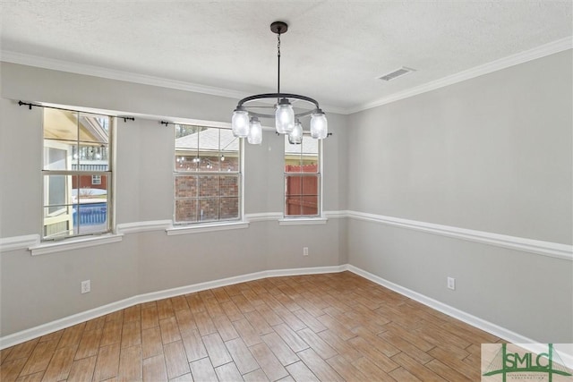 unfurnished dining area featuring visible vents, a textured ceiling, wood finished floors, baseboards, and a chandelier