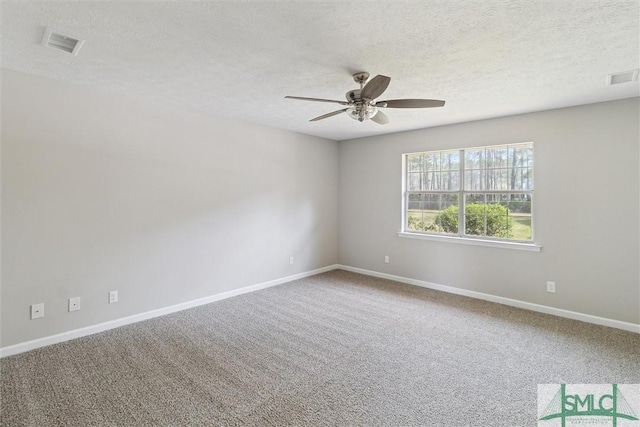 empty room featuring carpet, baseboards, visible vents, and ceiling fan