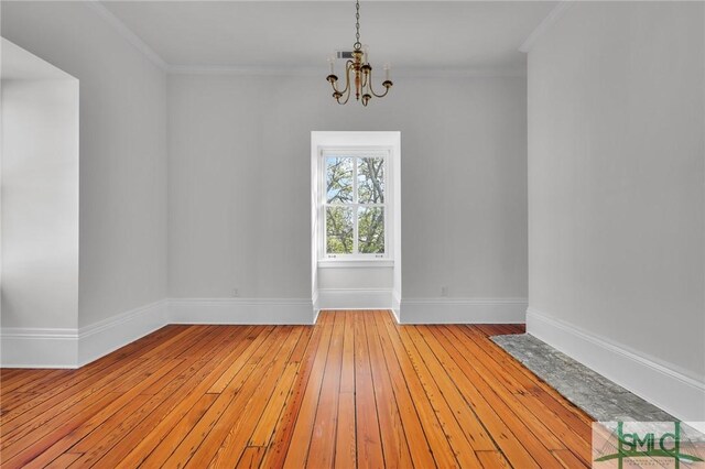 114 W Bolton St, Savannah, GA 31401 - spare room featuring a chandelier, light wood-style flooring, baseboards, and ornamental molding