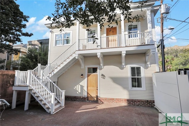 114 W Bolton St, Savannah, GA 31401 - rear view of property with stairs, fence, a patio, and a balcony