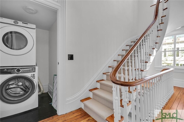 114 W Bolton St, Savannah, GA 31401 - clothes washing area featuring stacked washer and clothes dryer and wood finished floors