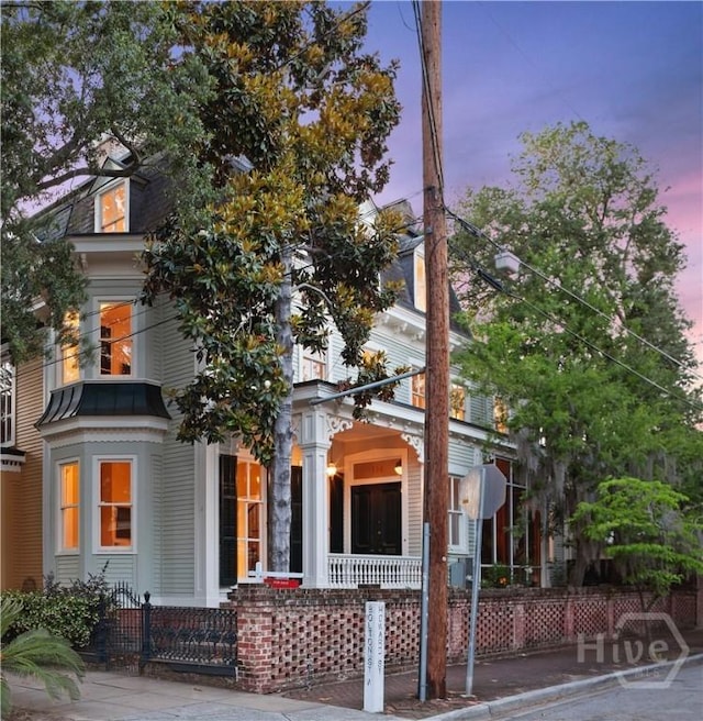 114 W Bolton St, Savannah, GA 31401 - victorian home with a porch, a standing seam roof, and metal roof