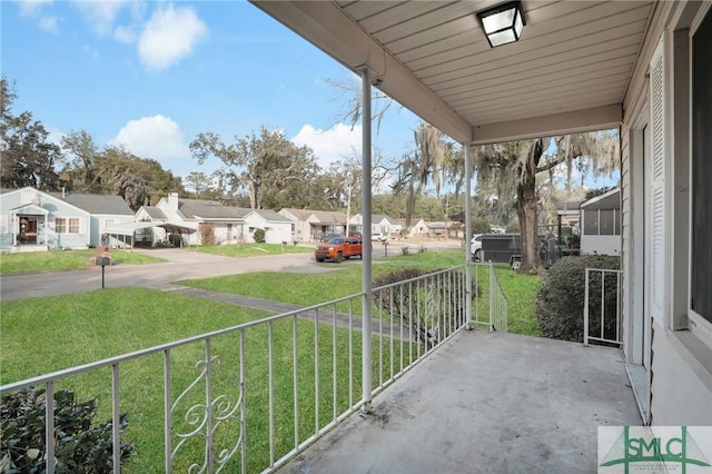 balcony featuring covered porch and a residential view