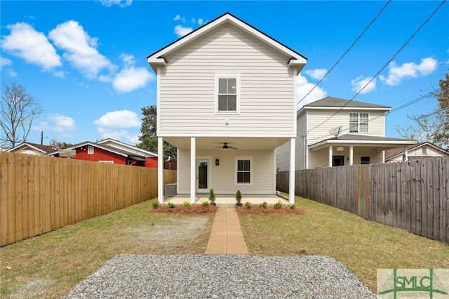 back of house featuring a patio, a lawn, a fenced backyard, and a ceiling fan