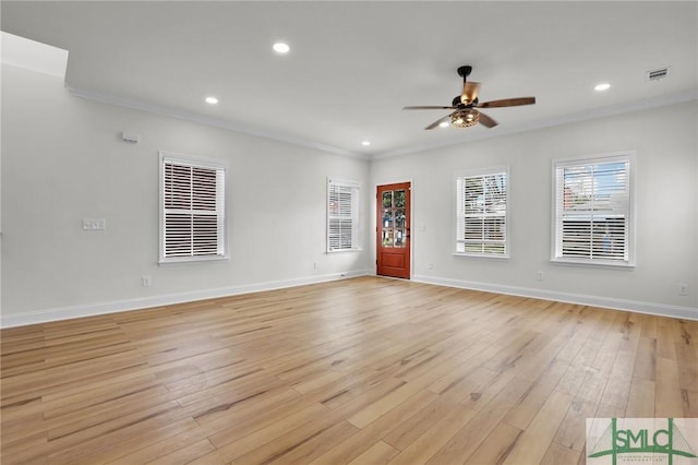 unfurnished living room with crown molding, light wood-style flooring, baseboards, and ceiling fan