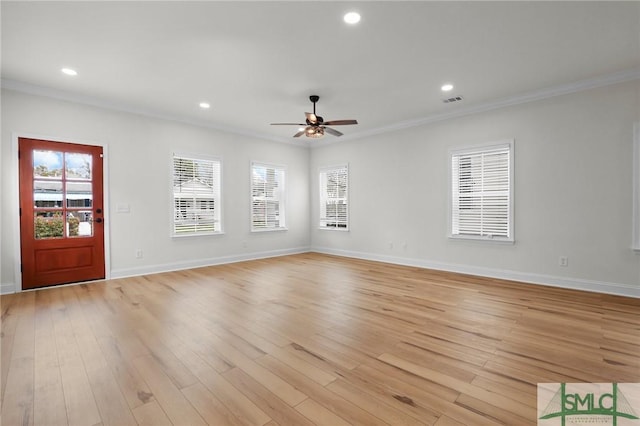 interior space with ornamental molding, a ceiling fan, recessed lighting, light wood finished floors, and baseboards