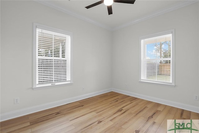 unfurnished room with ornamental molding, wood finished floors, baseboards, and ceiling fan