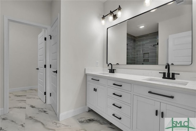 full bathroom with a sink, marble finish floor, and a stall shower