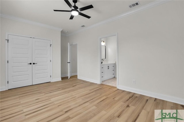 unfurnished bedroom with visible vents, baseboards, light wood-type flooring, ornamental molding, and a closet