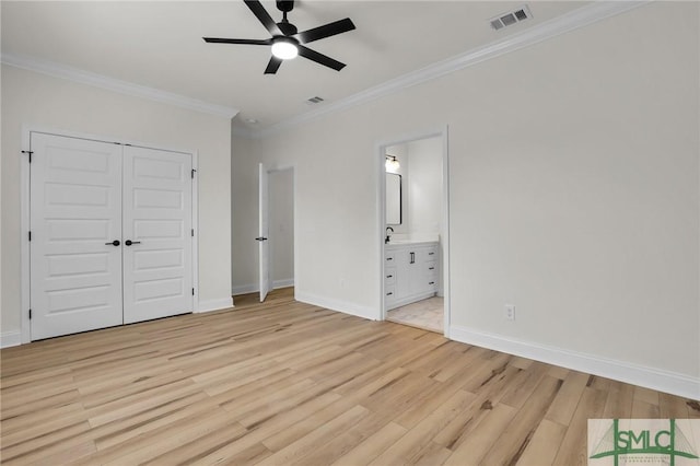 unfurnished bedroom with light wood-type flooring, visible vents, ensuite bath, crown molding, and baseboards