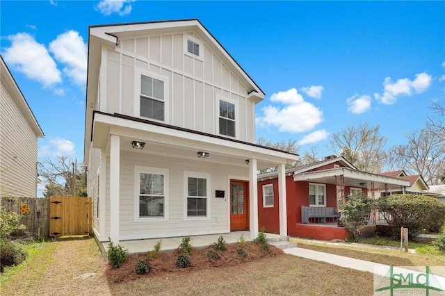 view of front of property featuring a porch, a gate, fence, and board and batten siding