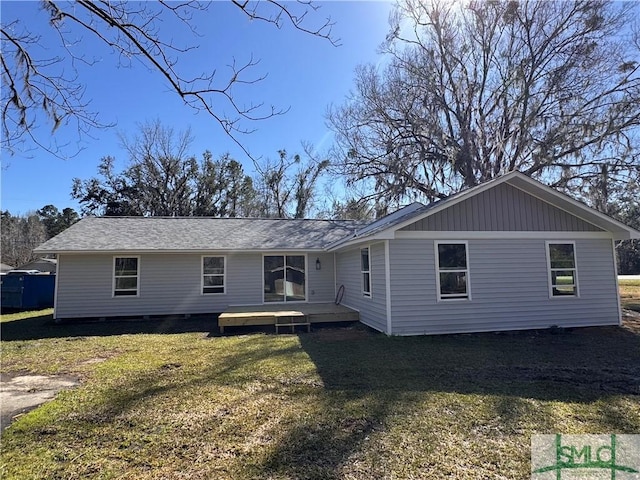 back of house with a lawn and a wooden deck