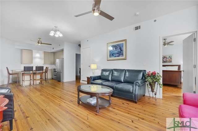 living area with light wood finished floors, visible vents, and a ceiling fan