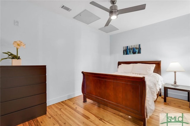 bedroom featuring visible vents, baseboards, wood finished floors, and a ceiling fan