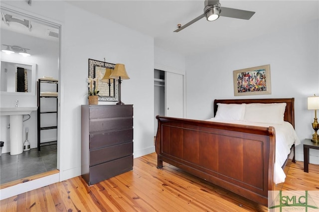 bedroom featuring light wood-type flooring, a closet, and visible vents