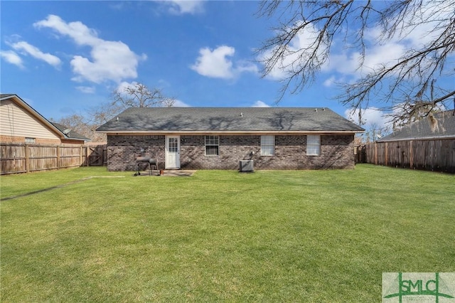 back of house featuring a lawn, cooling unit, and a fenced backyard