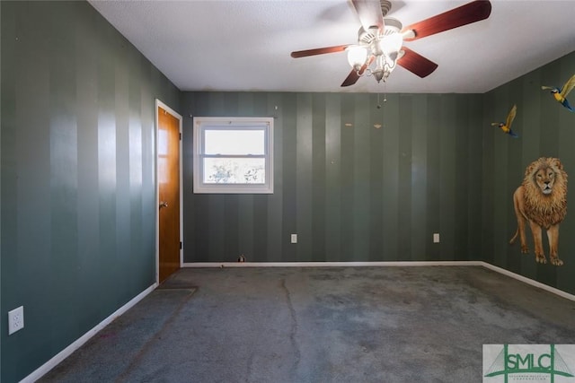 carpeted spare room with baseboards and ceiling fan