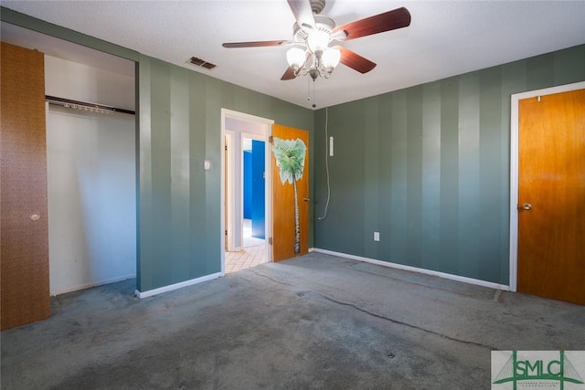 unfurnished bedroom with visible vents, carpet floors, baseboards, and a closet