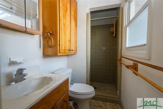 full bath featuring vanity, toilet, and a shower stall