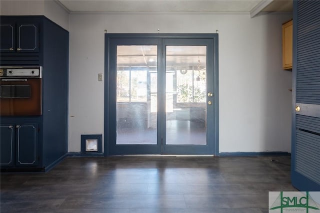 interior space with dark wood finished floors and crown molding