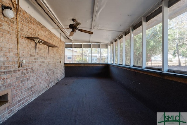 unfurnished sunroom with a ceiling fan