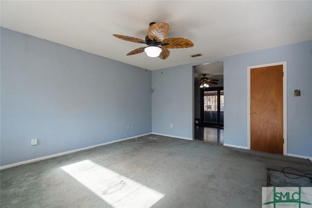 unfurnished room with visible vents, baseboards, a ceiling fan, and carpet flooring