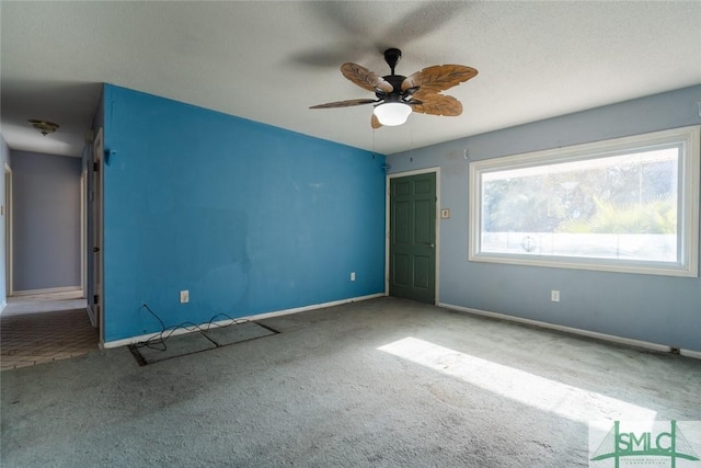 unfurnished bedroom with baseboards, carpet, and a ceiling fan