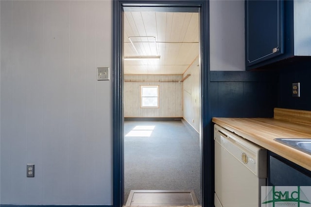 kitchen with carpet floors, blue cabinets, and white dishwasher