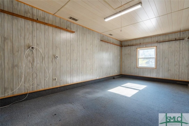 empty room with visible vents and carpet floors