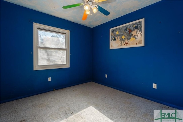 unfurnished room with a ceiling fan and carpet floors