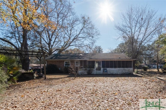 rear view of property with a sunroom