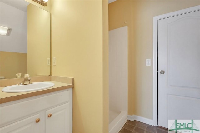 full bath featuring vanity, a shower stall, and tile patterned flooring